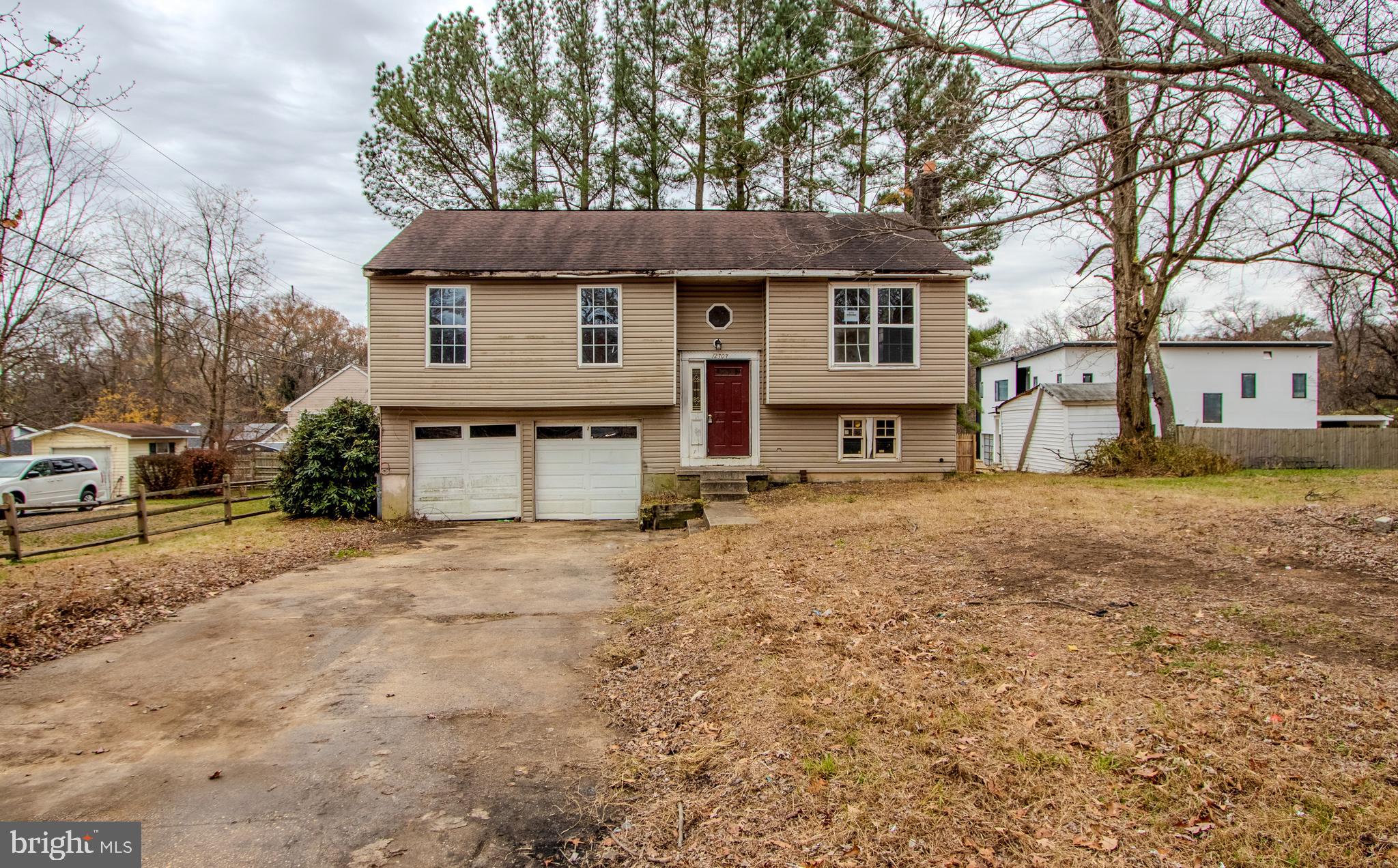 12707 Duckettown Road Laurel, MD 20708 - Photo 1 of 21 a front view of a house with a yard and garage