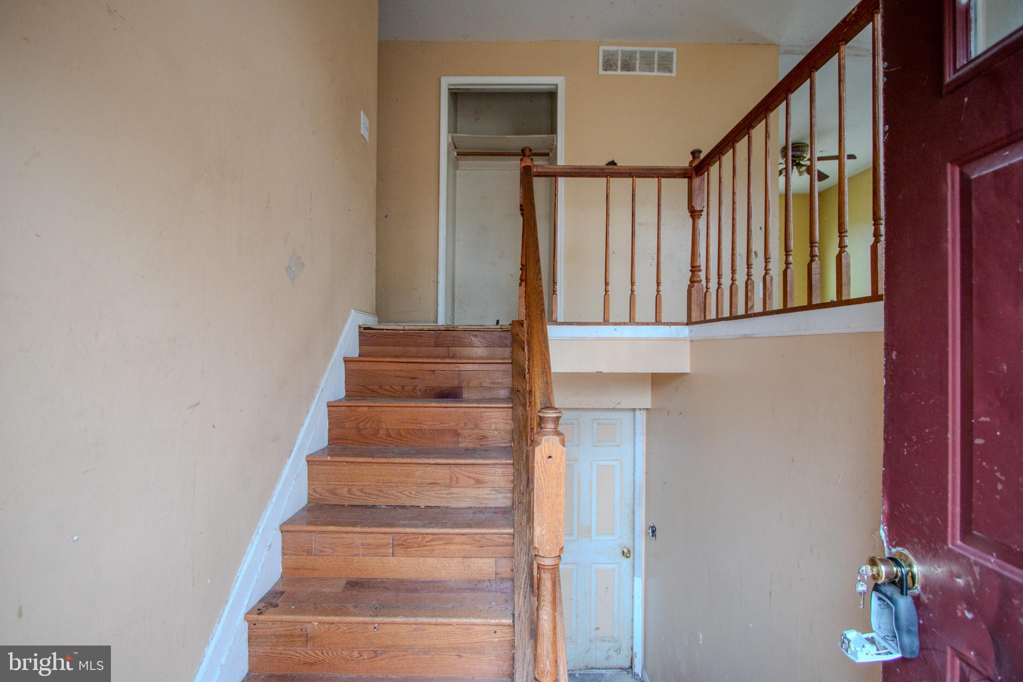 12707 Duckettown Road Laurel, MD 20708 - Photo 14 of 21 a view of staircase with lots of frames on wall and a window