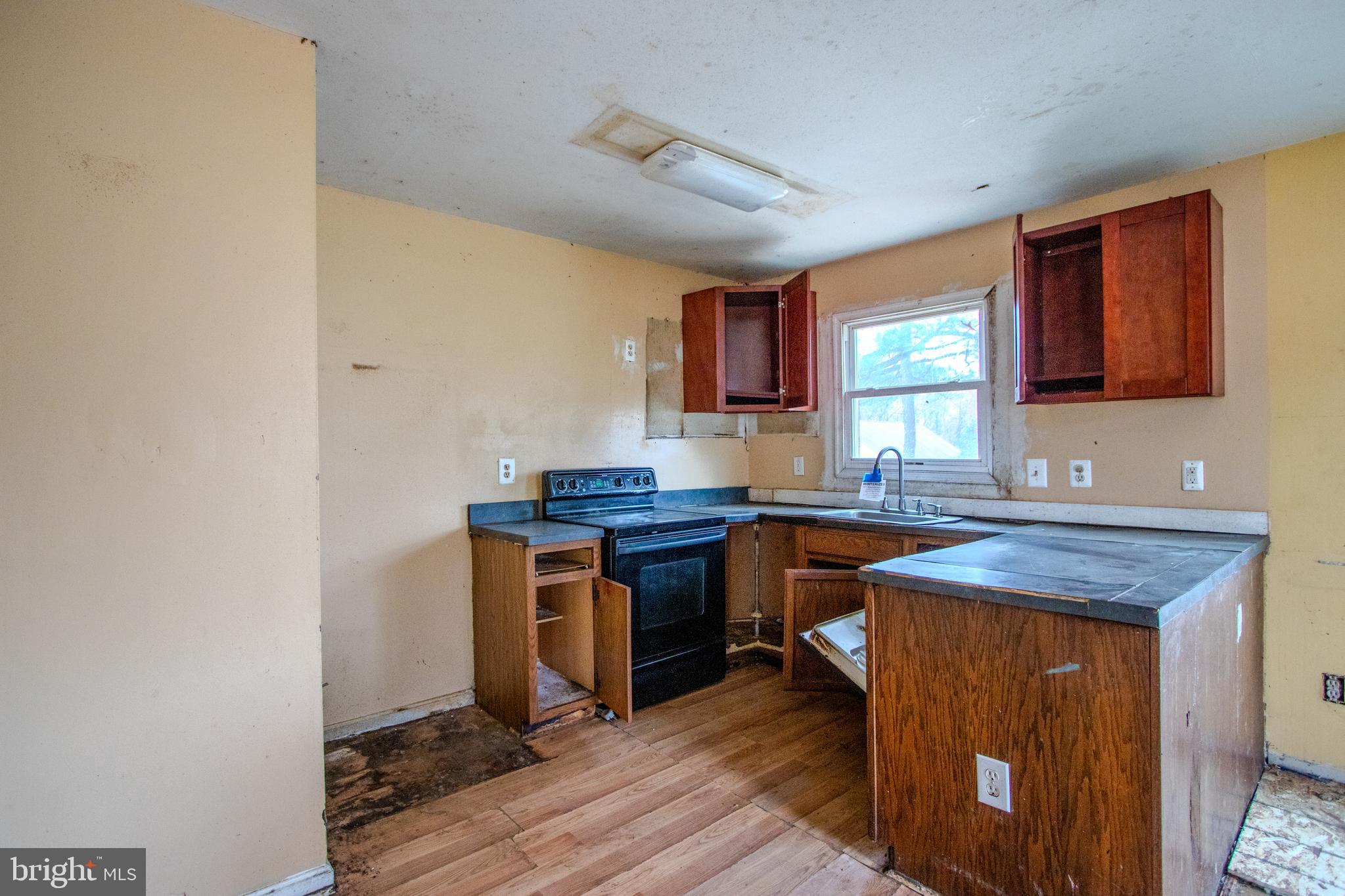 12707 Duckettown Road Laurel, MD 20708 - Photo 4 of 21 a kitchen with a sink cabinets and wooden floor