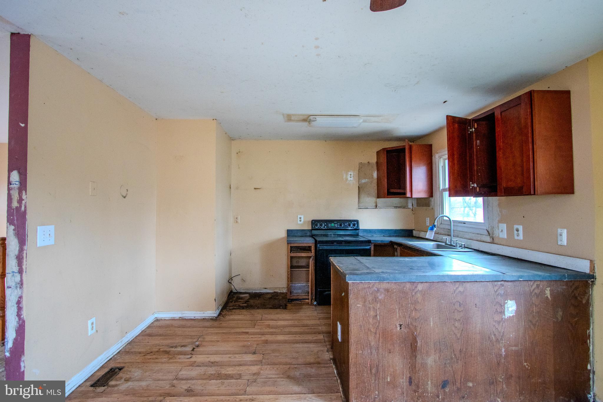 12707 Duckettown Road Laurel, MD 20708 - Photo 5 of 21 a kitchen with stainless steel appliances granite countertop a stove and a sink