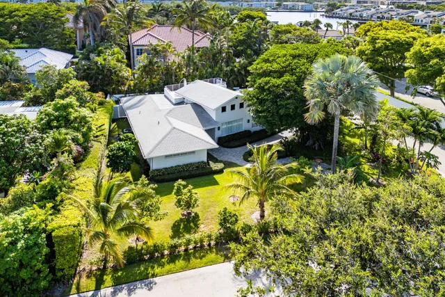 an aerial view of a house with a yard basket ball court and outdoor seating