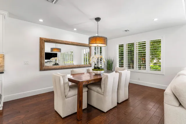 a kitchen with stainless steel appliances white cabinets and stove top oven