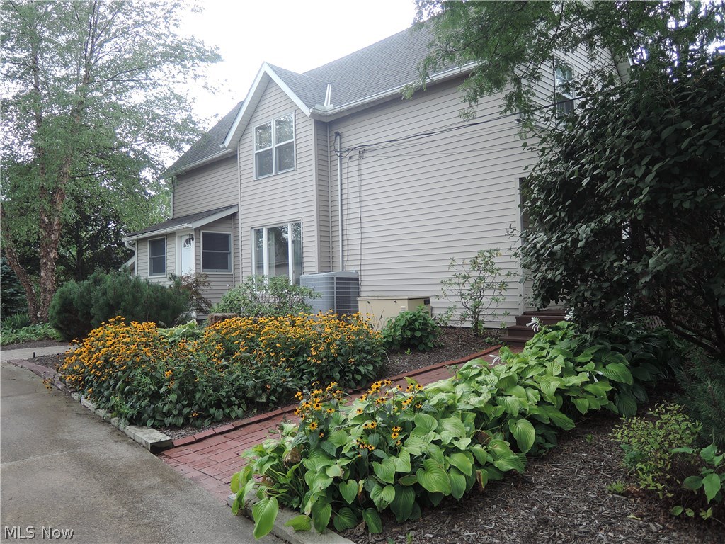 7593 Cedar Road Chesterland, OH 44026 - Photo 26 of 33 Perennial flowers & hostas by the brick sidewalk to the front door.
