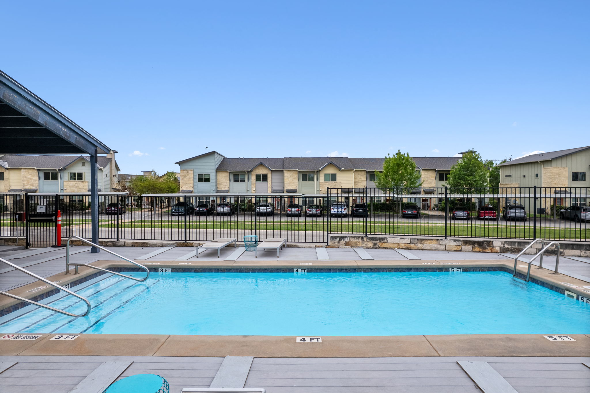 7805 Cooper Lane, Unit 606 Austin, TX 78745 - Photo 31 of 35 a view of a swimming pool with a lounge chair