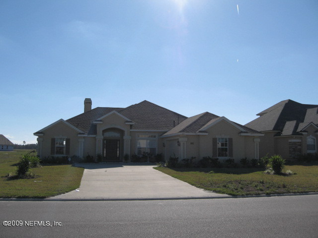 221 Porta Rosa Circle St. Augustine, FL 32092 - Photo 1 of 17 a front view of a house with a garden and yard