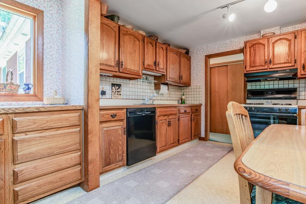 61 Hickory Road Sudbury, MA 01776 - Photo 14 of 29 a kitchen with stainless steel appliances granite countertop a stove microwave and cabinets