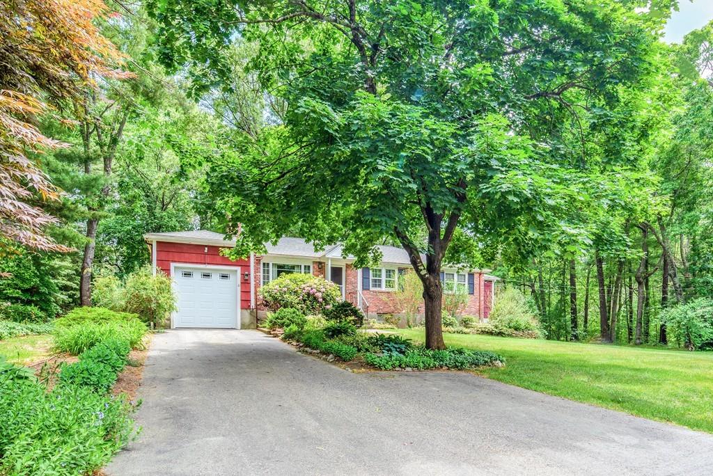 61 Hickory Road Sudbury, MA 01776 - Photo 2 of 29 a sign board with flower plants and large trees