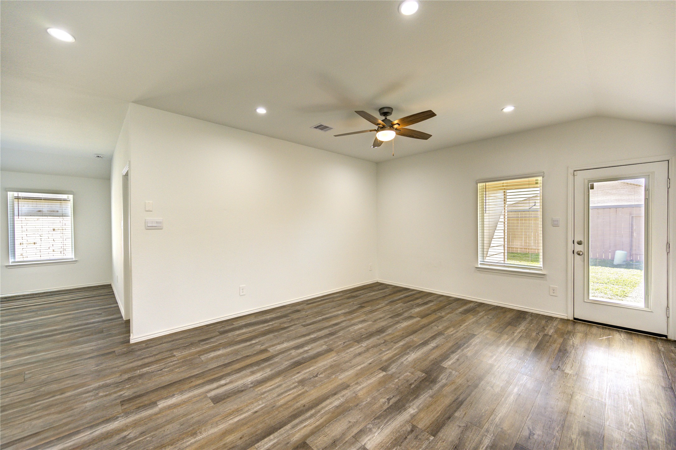 5406 Castlebury Meadows Dr Spring Spring, TX 77373 - Photo 12 of 34 an empty room with wooden floor and windows