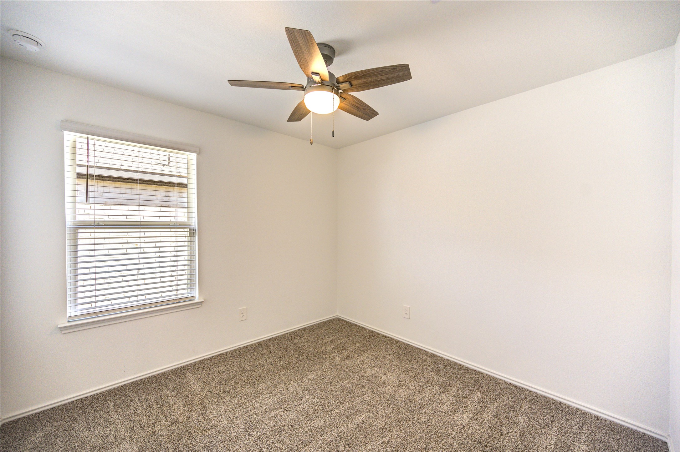5406 Castlebury Meadows Dr Spring Spring, TX 77373 - Photo 23 of 34 an empty room with a window and a ceiling fan