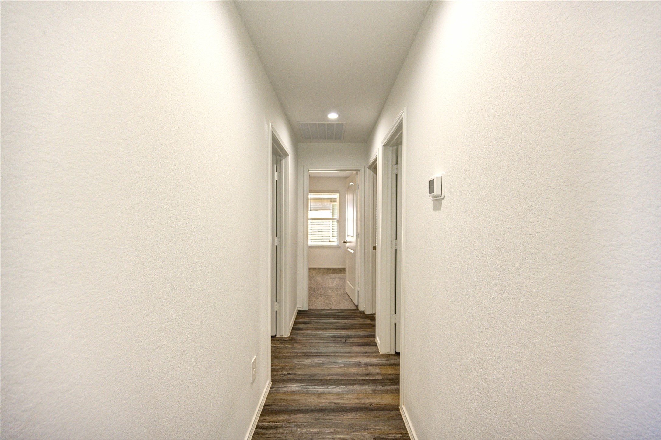 5406 Castlebury Meadows Dr Spring Spring, TX 77373 - Photo 7 of 34 a view of a hallway with wooden floor and closet