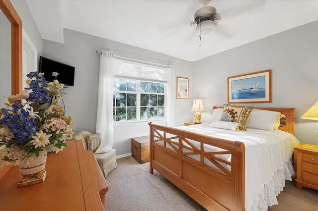 a bed room with a bed and a potted plant