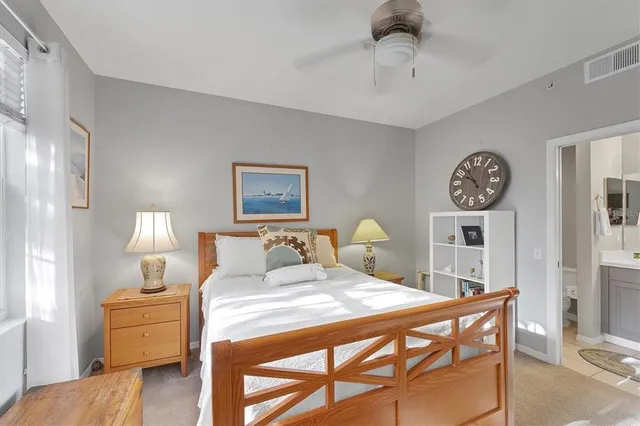 a bedroom with a bed and a lamp on table