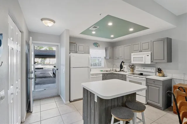 a kitchen with a sink a refrigerator and cabinets