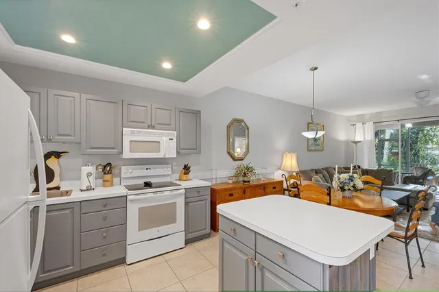 a kitchen that has a lot of cabinets in it and appliances
