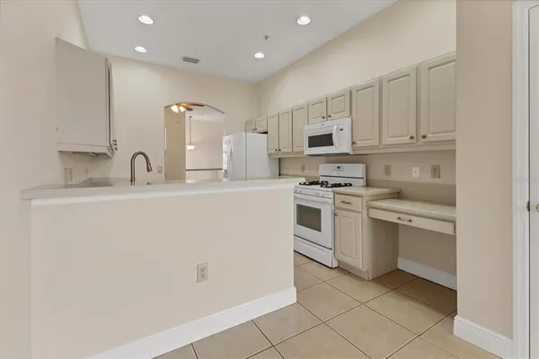 a kitchen with appliances a sink and cabinets