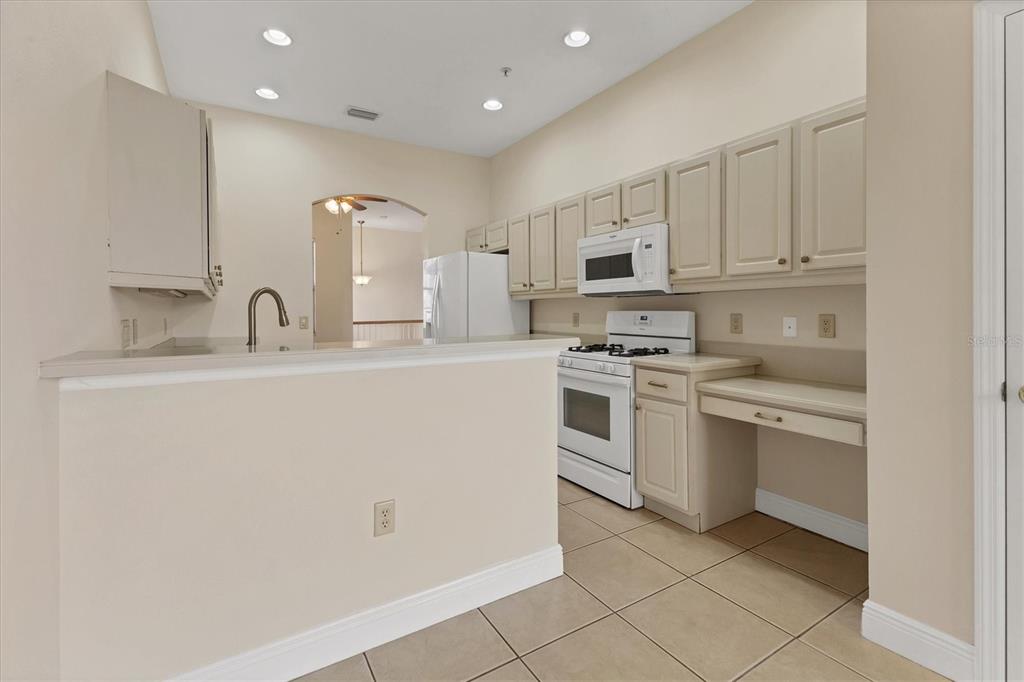 8411 Miramar Way, Unit 202 Lakewood Ranch, FL 34202 - Photo 13 of 37 a kitchen with appliances a sink and cabinets