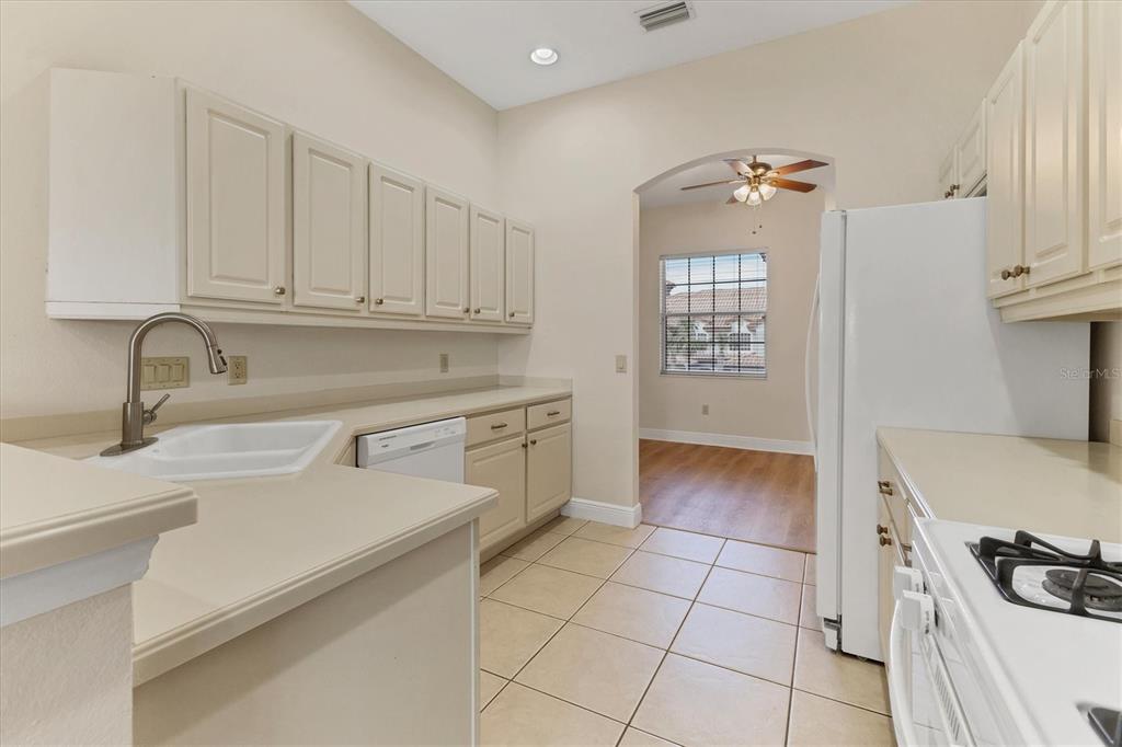 8411 Miramar Way, Unit 202 Lakewood Ranch, FL 34202 - Photo 14 of 37 a kitchen with a sink stove and cabinets