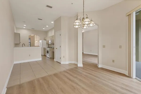 a view of a kitchen with an entryway and a chandelier