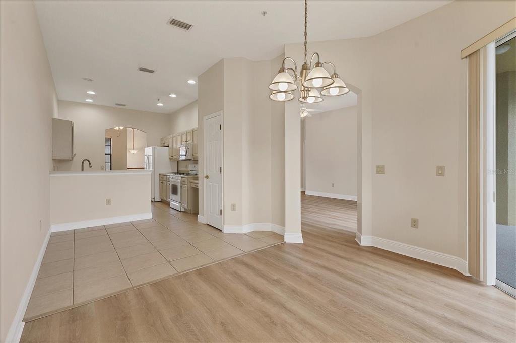 8411 Miramar Way, Unit 202 Lakewood Ranch, FL 34202 - Photo 18 of 37 a view of a kitchen with an entryway and a chandelier