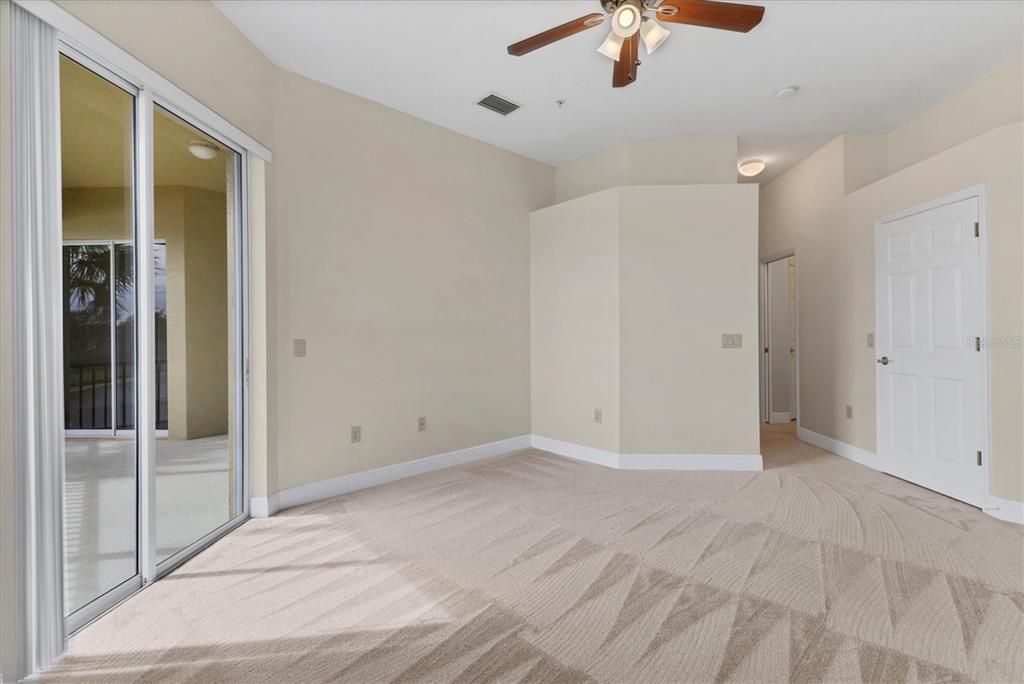8411 Miramar Way, Unit 202 Lakewood Ranch, FL 34202 - Photo 20 of 37 a view of an empty room with a ceiling fan