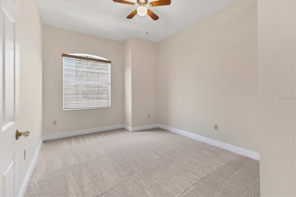 8411 Miramar Way, Unit 202 Lakewood Ranch, FL 34202 - Photo 22 of 37 an empty room with a window and a ceiling fan