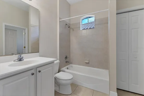 a bathroom with a bathtub shower sink vanity and a toilet