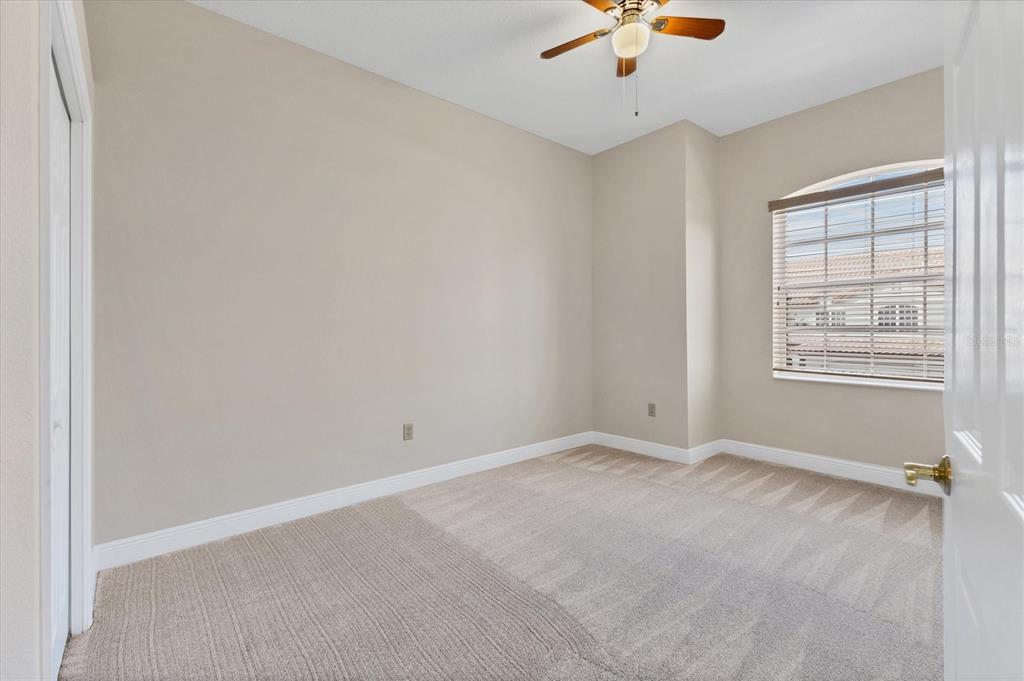 8411 Miramar Way, Unit 202 Lakewood Ranch, FL 34202 - Photo 24 of 37 an empty room with a ceiling fan and window