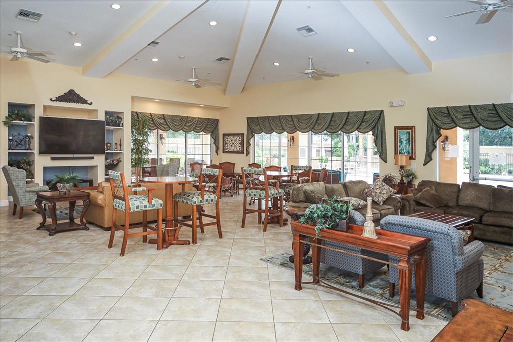 8411 Miramar Way, Unit 202 Lakewood Ranch, FL 34202 - Photo 32 of 37 a living room with lots of furniture and a flat screen tv
