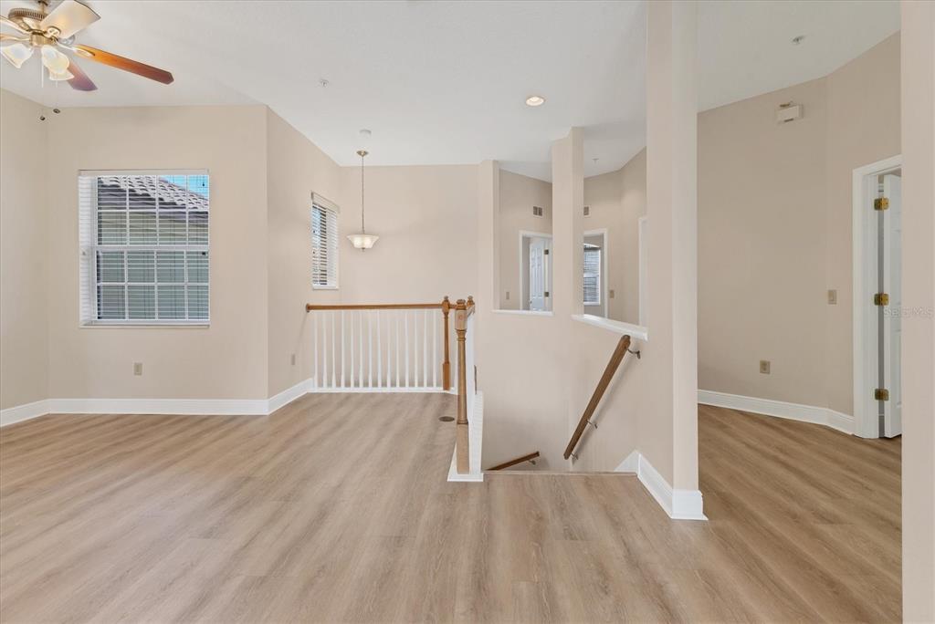 8411 Miramar Way, Unit 202 Lakewood Ranch, FL 34202 - Photo 9 of 37 a view of an empty room with wooden floor and a window