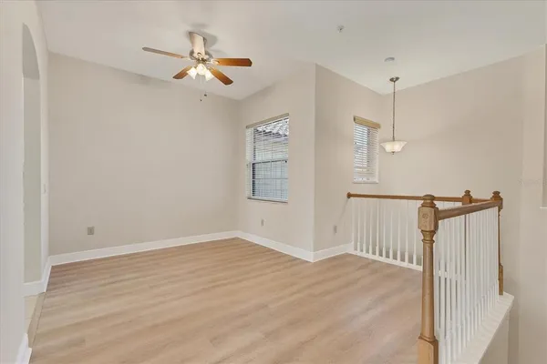 a view of a room with wooden floor ceiling fan