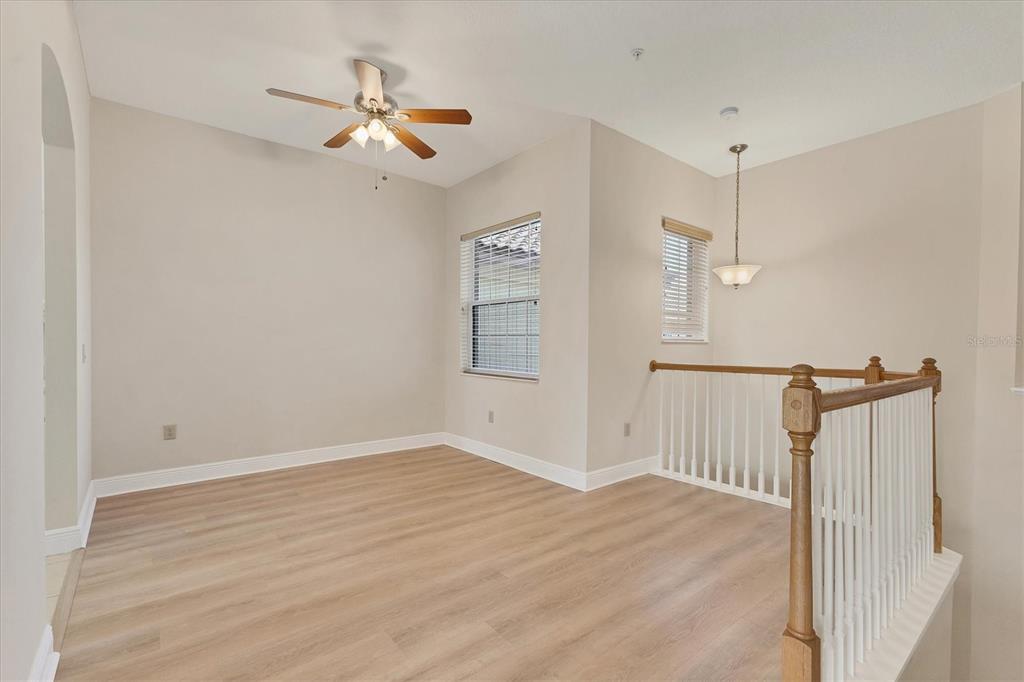 8411 Miramar Way, Unit 202 Lakewood Ranch, FL 34202 - Photo 10 of 37 a view of a room with wooden floor ceiling fan