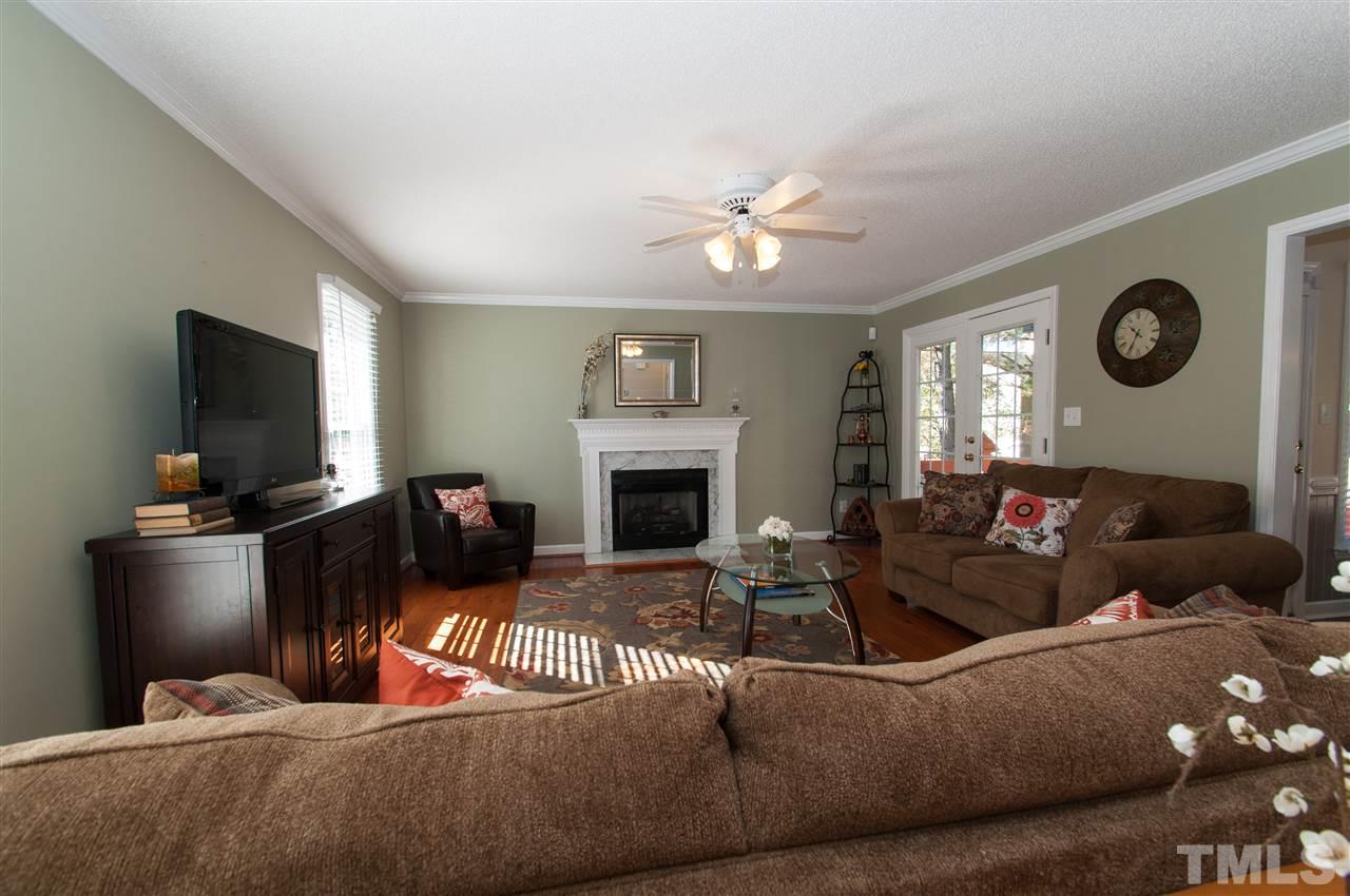 3205 Arden Branch Lane Raleigh, NC 27616 - Photo 2 of 22 a living room with furniture a flat screen tv and a fireplace