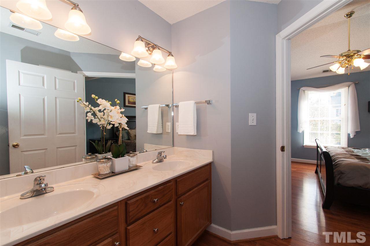 3205 Arden Branch Lane Raleigh, NC 27616 - Photo 14 of 22 a bathroom with a double vanity sink and a mirror