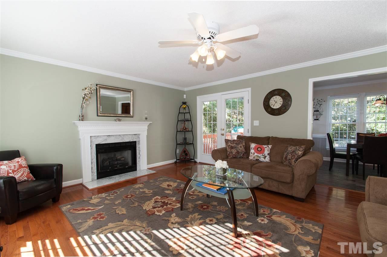 3205 Arden Branch Lane Raleigh, NC 27616 - Photo 3 of 22 a living room with furniture a clock and a window