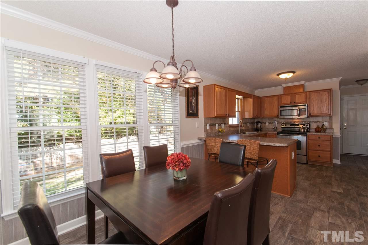 3205 Arden Branch Lane Raleigh, NC 27616 - Photo 9 of 22 a view of a dining room and livingroom furniture a chandelier and wooden floor
