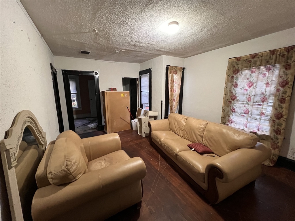 34 Wellesley Street Springfield, MA 01109 - Photo 2 of 11 a living room with furniture and a couch
