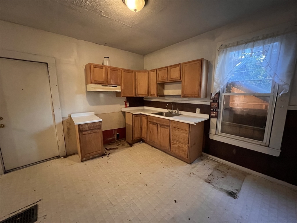 34 Wellesley Street Springfield, MA 01109 - Photo 3 of 11 a kitchen with a stove top oven and sink