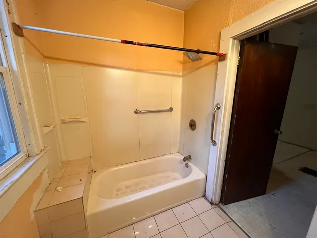 a bathroom with a shower and a bath tub