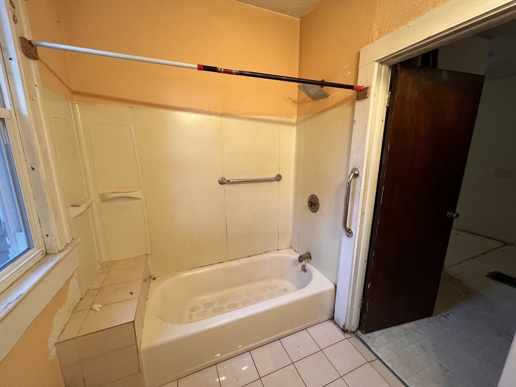 34 Wellesley Street Springfield, MA 01109 - Photo 6 of 11 a bathroom with a shower and a bath tub