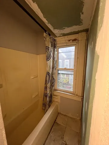 a bathroom with a bathtub and shower