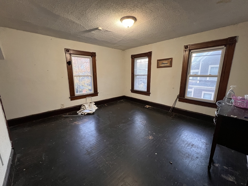 34 Wellesley Street Springfield, MA 01109 - Photo 9 of 11 a view of empty room with wooden floor and fan