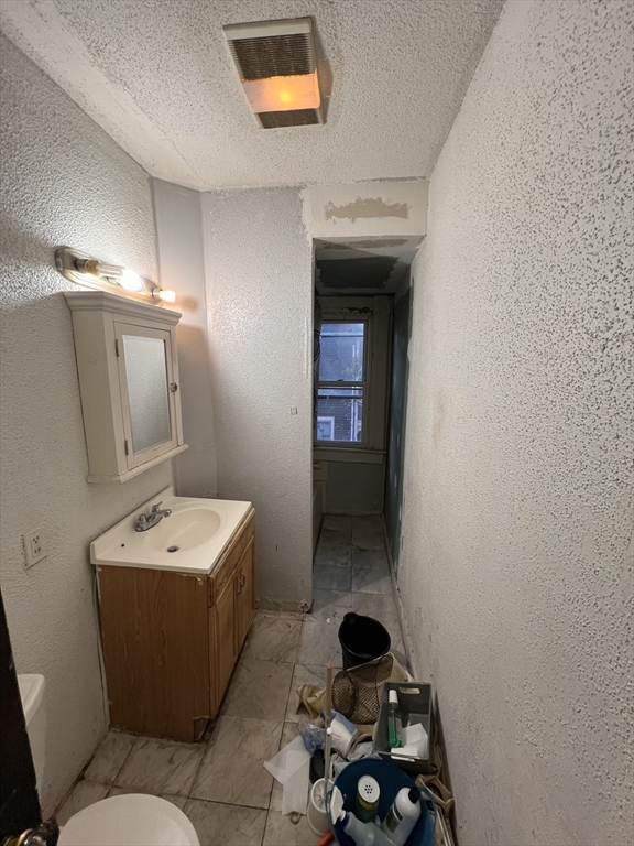 34 Wellesley Street Springfield, MA 01109 - Photo 10 of 11 a bathroom with a sink toilet and vanity