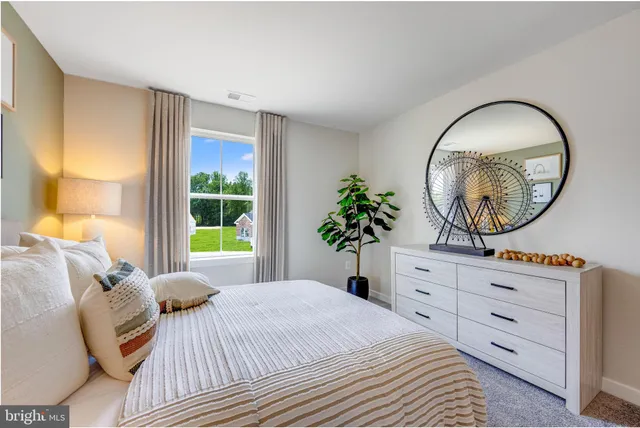 a bedroom with a bed and a mirror on dresser