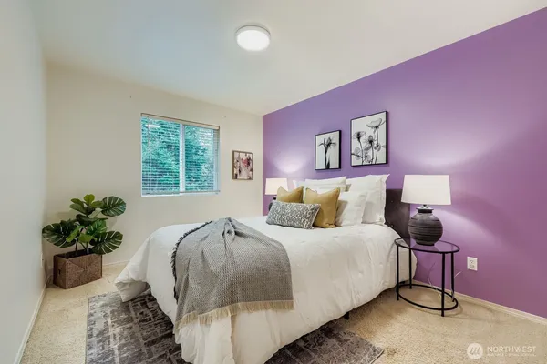a bedroom with a bed and a potted plant