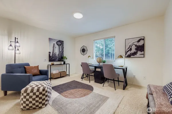 a living room with furniture rug and window