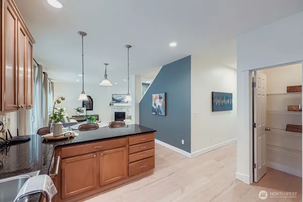 a kitchen with stainless steel appliances kitchen island granite countertop a sink and a refrigerator