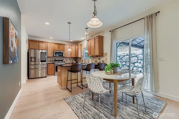 a kitchen with refrigerator a sink and chairs