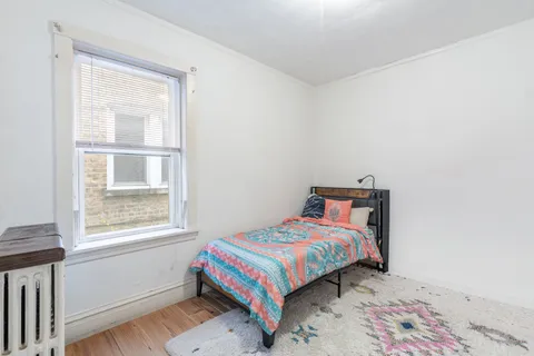 a bedroom with a bed and a window