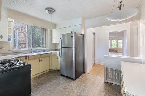 a kitchen with a refrigerator and a sink