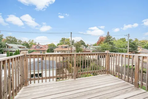 a view of a balcony with wooden floor